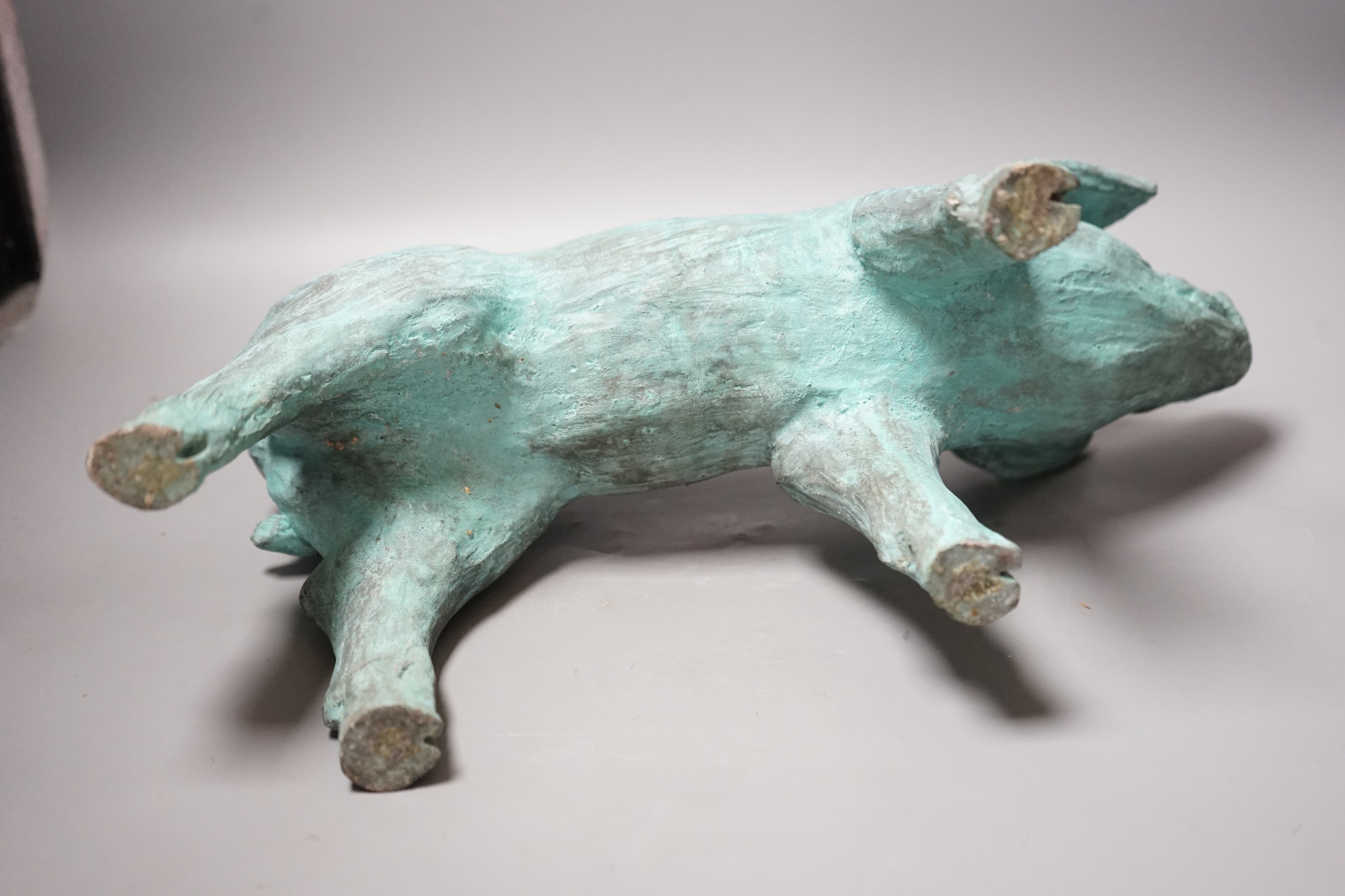 A cold cast resin bronze pig initialled 'JP', 40cm wide